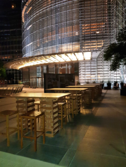 pallet bar tables with wooden barstools in a hotel facade
