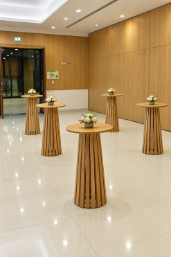 Maxwell round wooden high tables with tapered slatted bases for event rental in Dubai